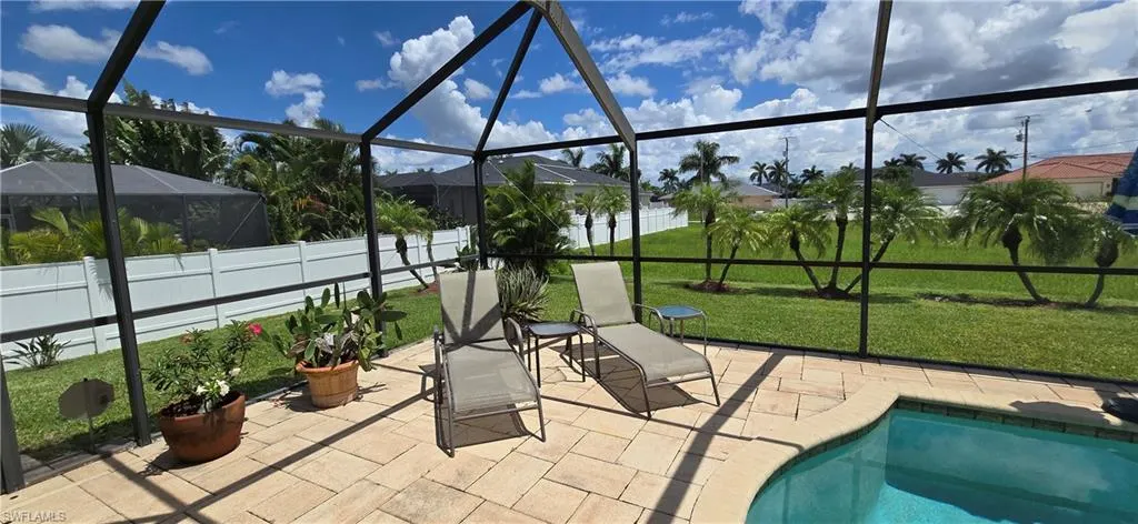 View of patio featuring a fenced in pool and glass enclosure
