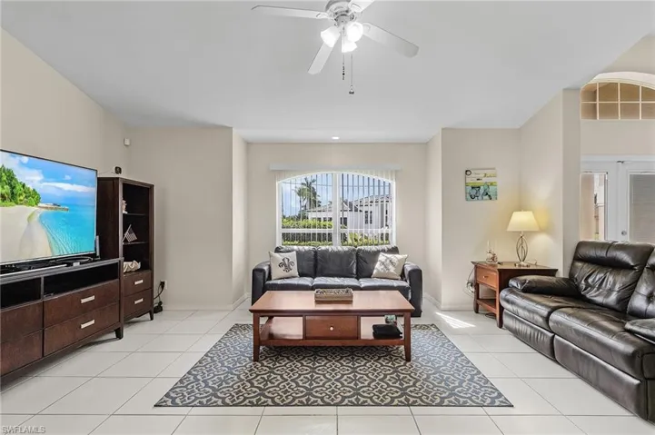 Tiled living room featuring ceiling fan