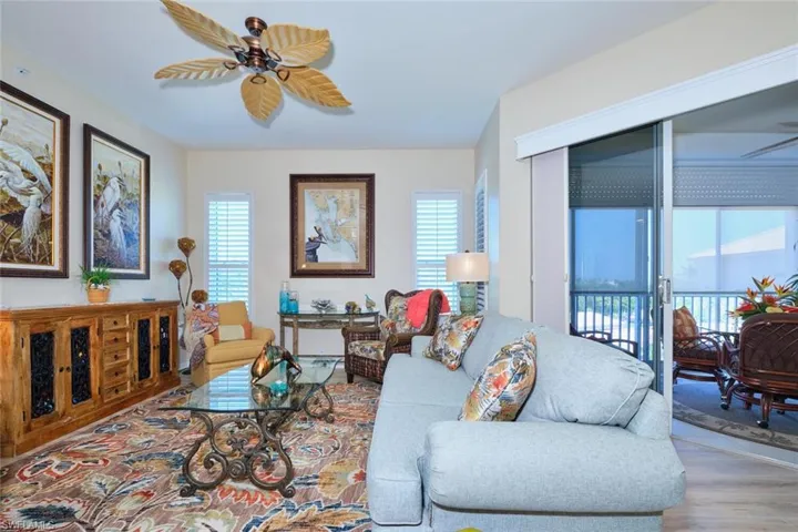 Living room with wood finished floors and a ceiling fan