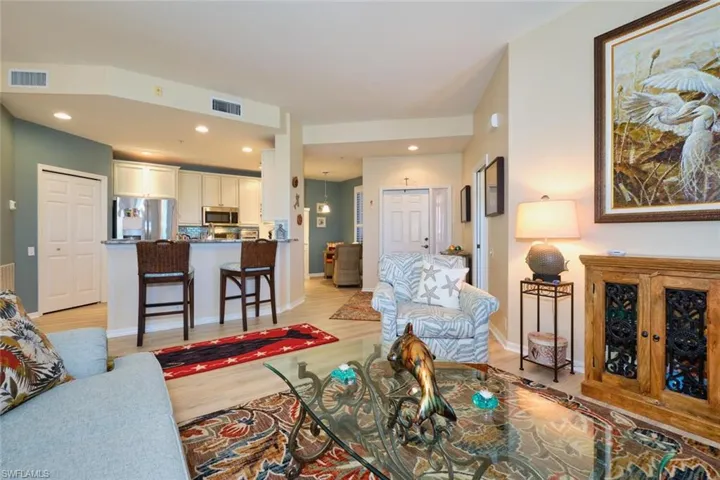 Living room with visible vents, recessed lighting, light wood-type flooring, and baseboards