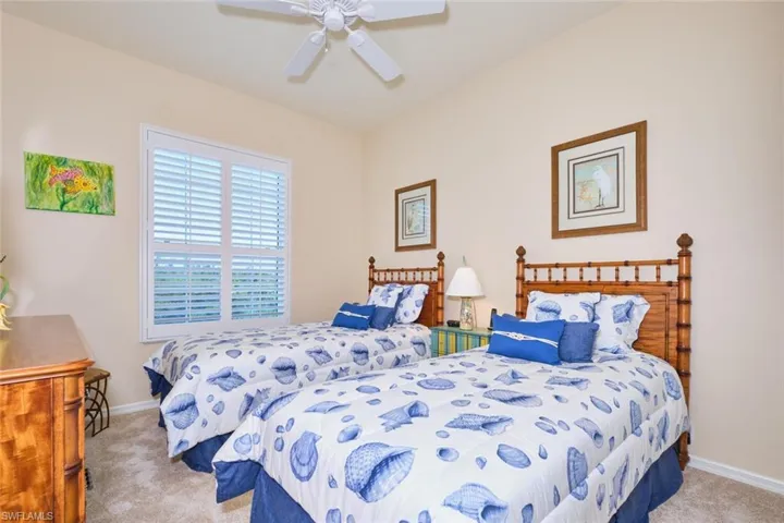 Carpeted bedroom with baseboards and ceiling fan