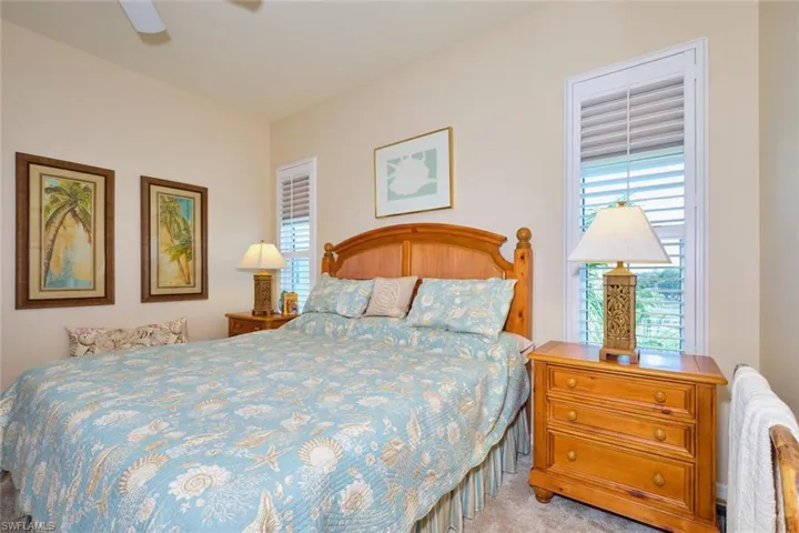 Bedroom featuring multiple windows, a ceiling fan, and carpet flooring
