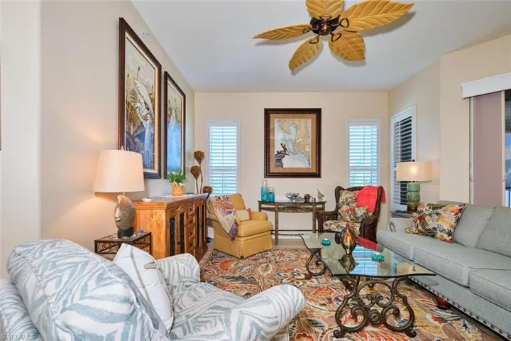Living room with a healthy amount of sunlight and a ceiling fan