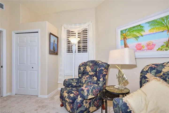 Living area featuring baseboards and carpet floors