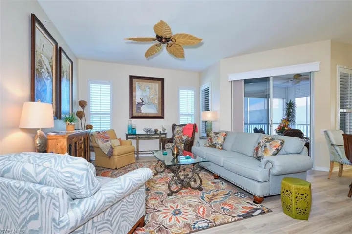 Living area with light wood-style flooring, baseboards, and ceiling fan