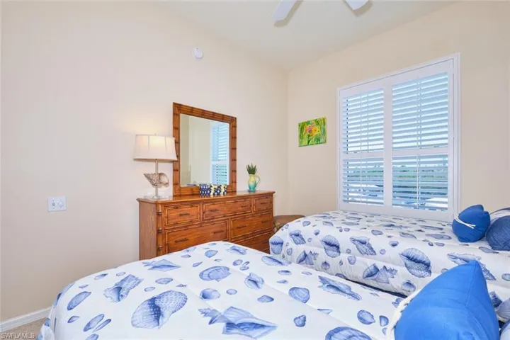 Carpeted bedroom featuring a ceiling fan and baseboards