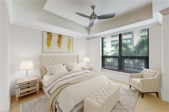 Tray ceiling featuring crown molding and a ceiling fan