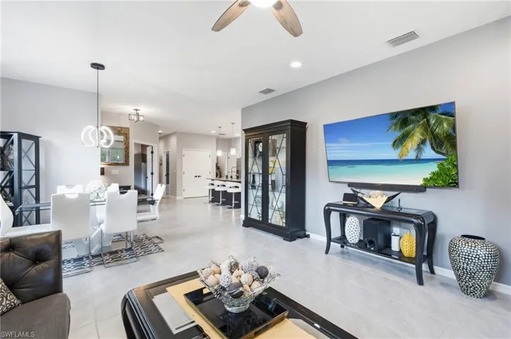 Open-concept living area featuring light gray wall paint and tile flooring throughout