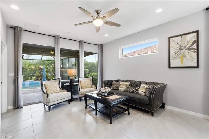 Spacious interior room featuring tile flooring and a ceiling fan