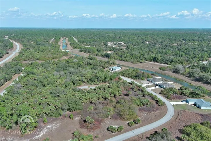 Aerial overview of property's location with a heavily wooded area