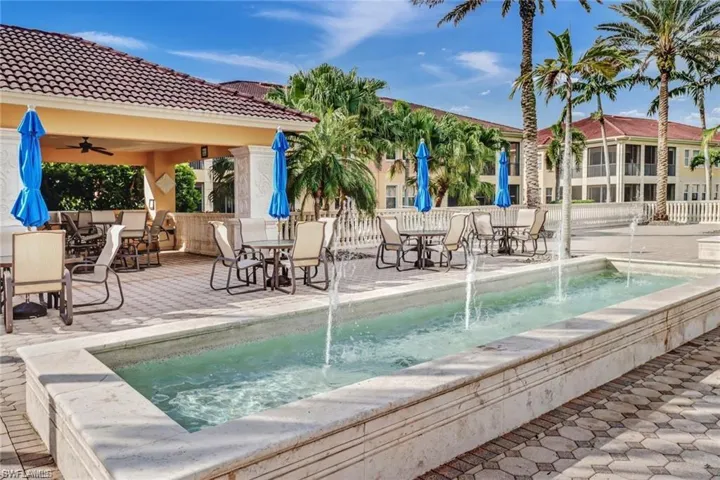 View of pool featuring an in ground hot tub, pool water feature, a patio area, and ceiling fan