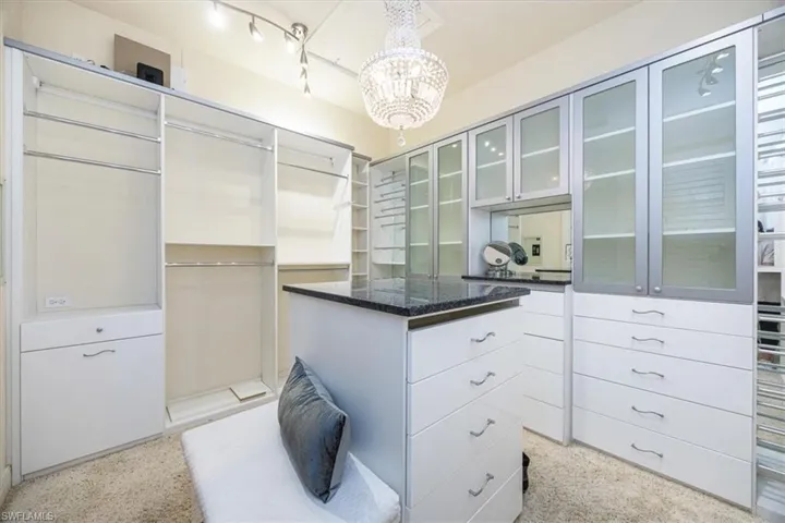 Spacious closet featuring a chandelier