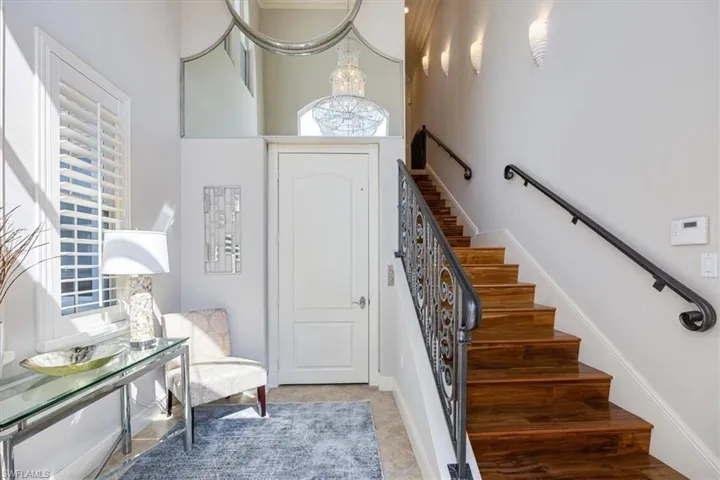 Staircase featuring a high ceiling and a elevator