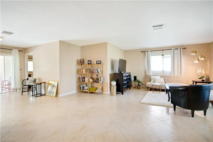 Living room featuring light tile floors