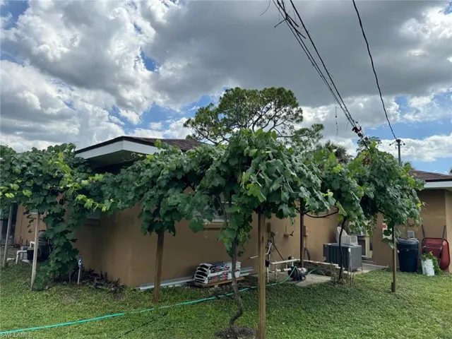 View of side of home featuring a yard