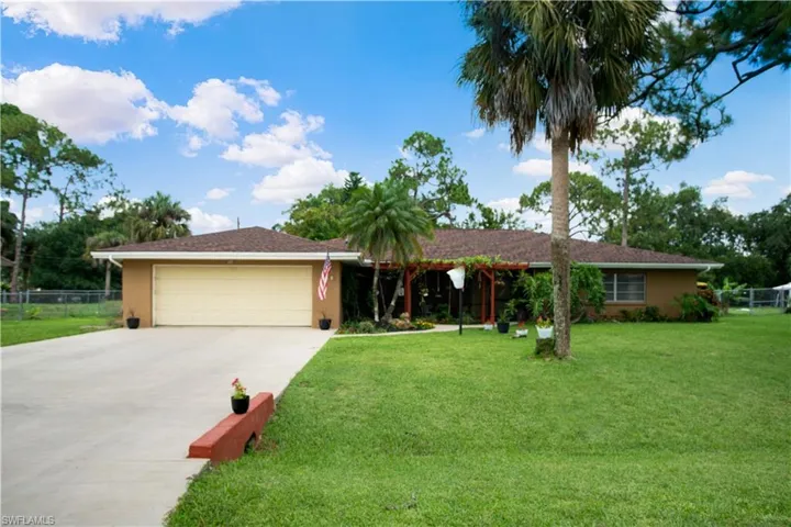 Single story home with a front lawn and a garage