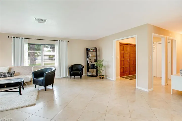 Living room featuring light tile floors