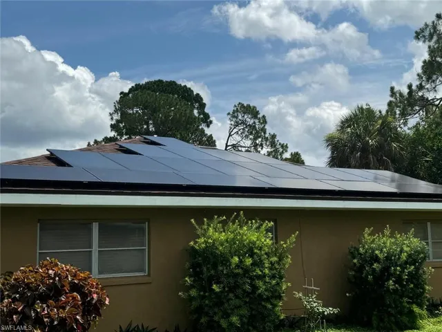View of side of property featuring solar panels