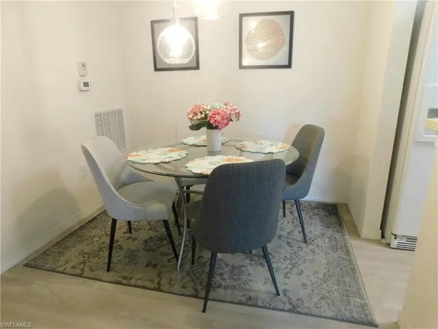 Dining space with light hardwood / wood-style floors