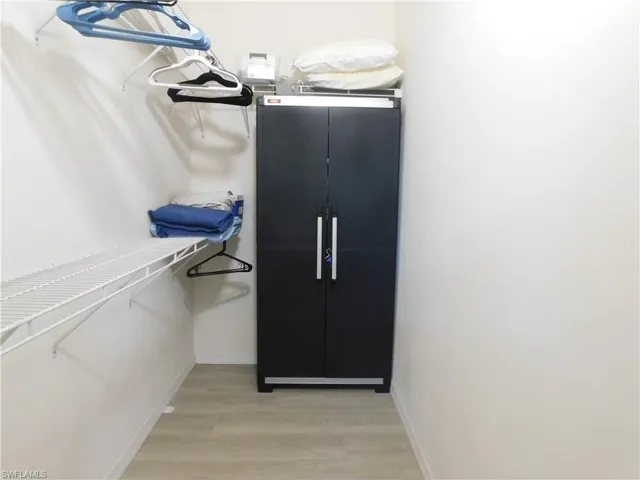 Spacious closet featuring light hardwood / wood-style floors