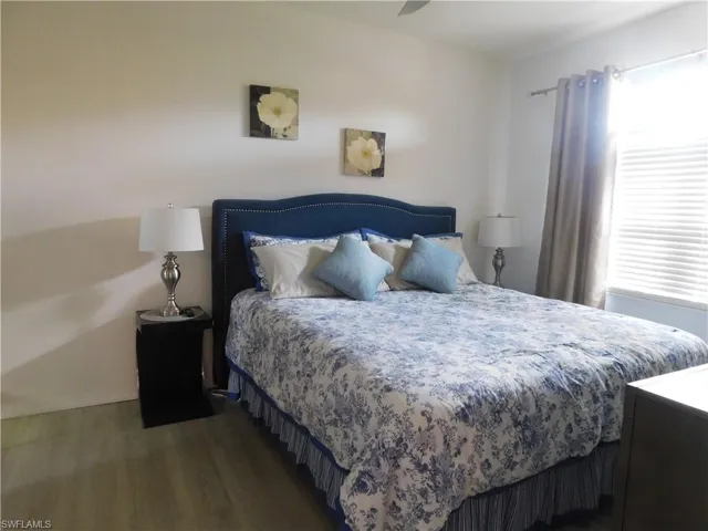 Bedroom with ceiling fan and hardwood / wood-style floors