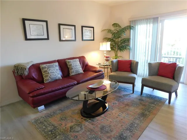 Living room with hardwood / wood-style flooring
