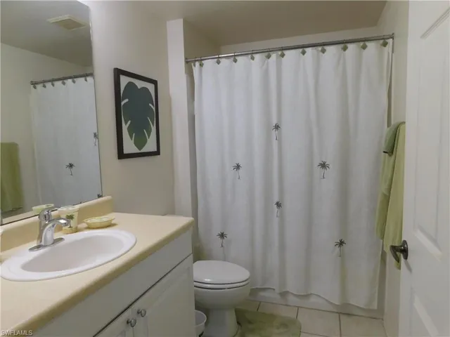 Bathroom with vanity, tile patterned flooring, and toilet