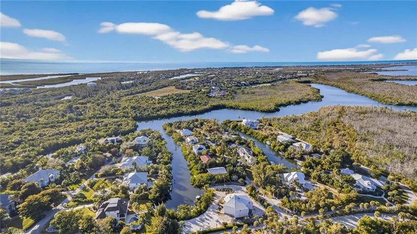 Aerial perspective of suburban area with a nearby body of water