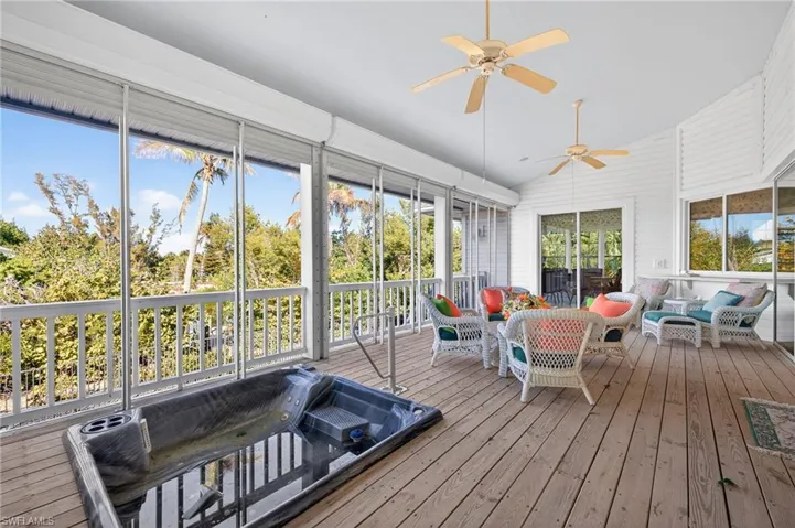Sunroom featuring an outdoor living space, a ceiling fan, lofted ceiling, and a deck