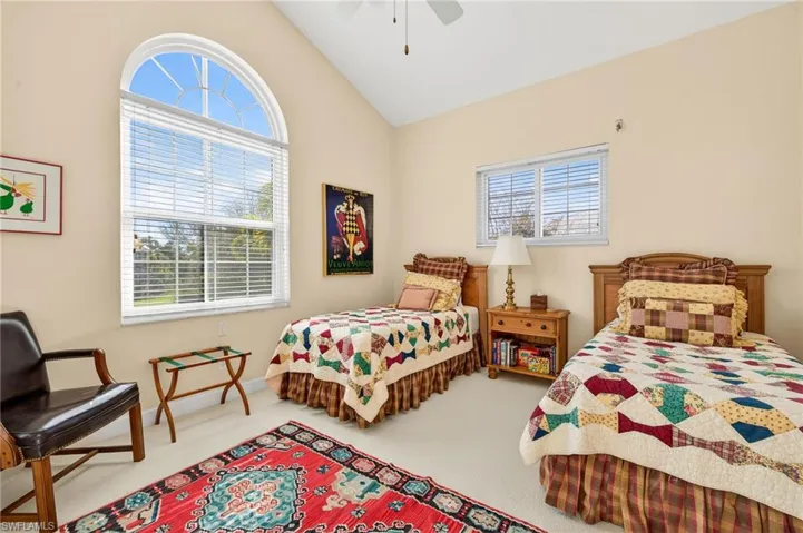 Bedroom featuring lofted ceiling, carpet floors, and a ceiling fan
