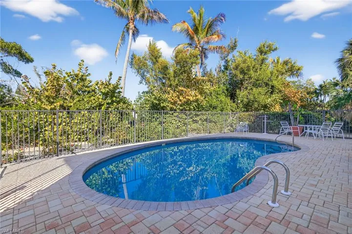 View of pool with a fenced backyard and patio surround