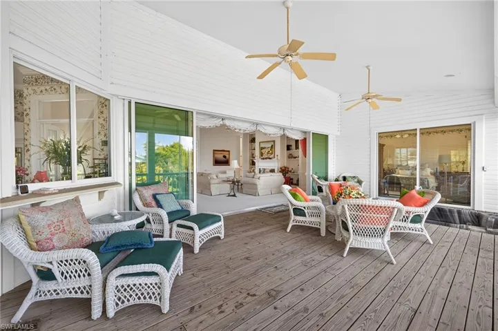 Sunroom / solarium featuring an outdoor lounge area, ceiling fan, a deck, and lofted ceiling