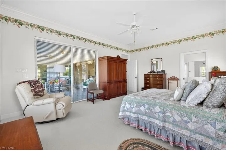 Carpeted bedroom with access to outside, ornamental molding, and ceiling fan