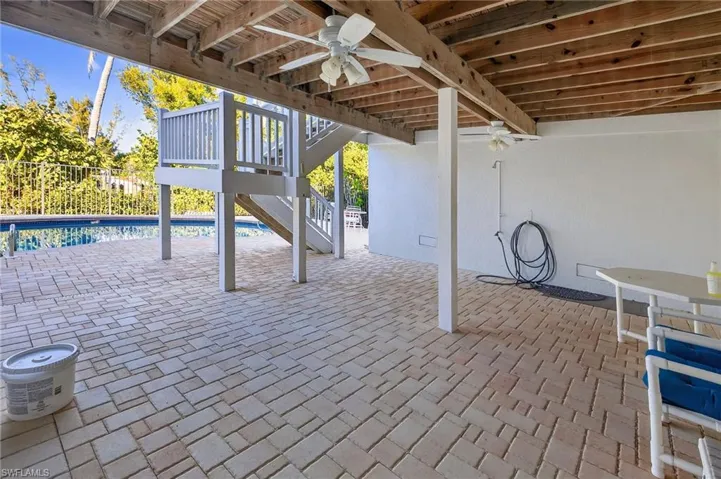 View of patio featuring a ceiling fan and a deck