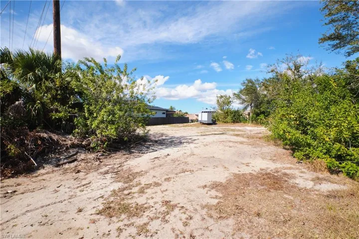 View of yard with a storage unit