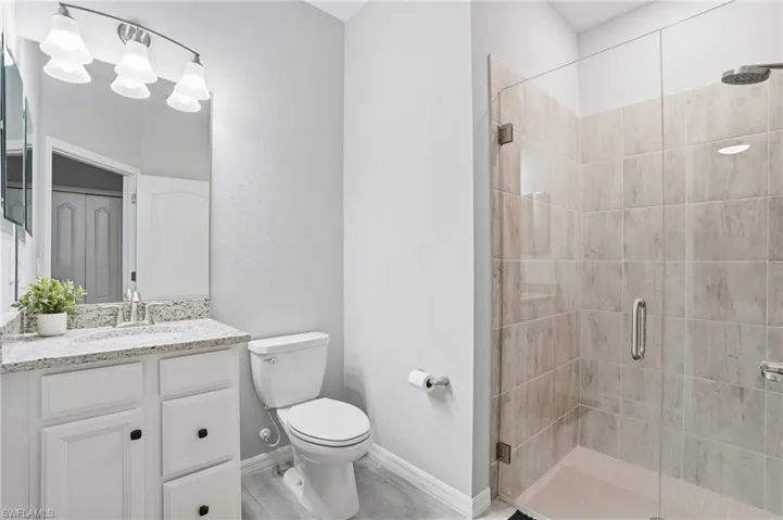Ensuite bathroom with walk in tiled shower with glass door