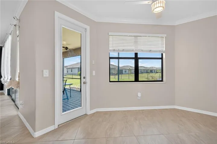 Entryway featuring ceiling fan, crown molding, and tile patterned floors