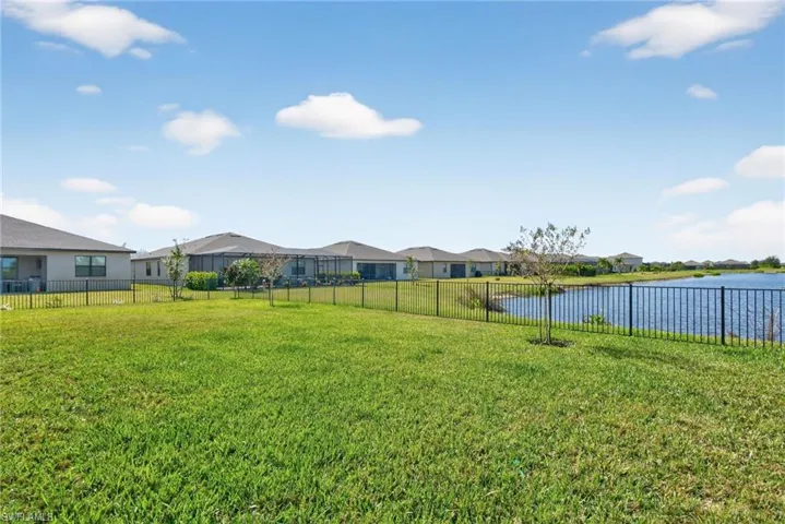 Fenced backyard with a residential view and a water view