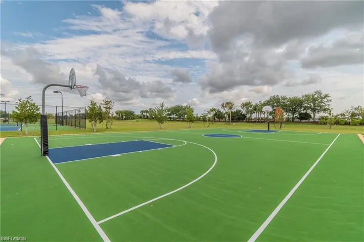 View of basketball court featuring community basketball court and a yard