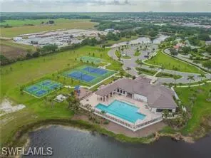 Aerial view of property's location featuring a pool and a large body of water
