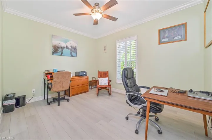 Office space featuring light hardwood / wood-style flooring, ceiling fan, and ornamental molding