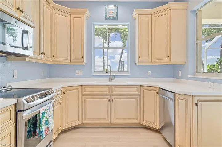 Kitchen with sink, a wealth of natural light, and stainless steel appliances