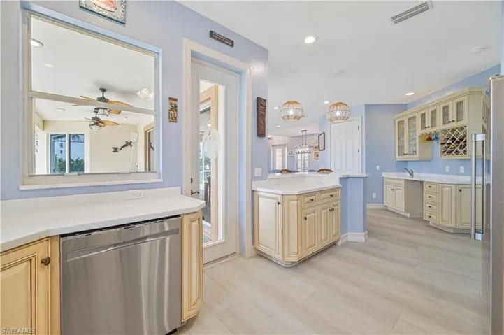 Kitchen with cream cabinets, ceiling fan, sink, light hardwood / wood-style floors, and appliances with stainless steel finishes