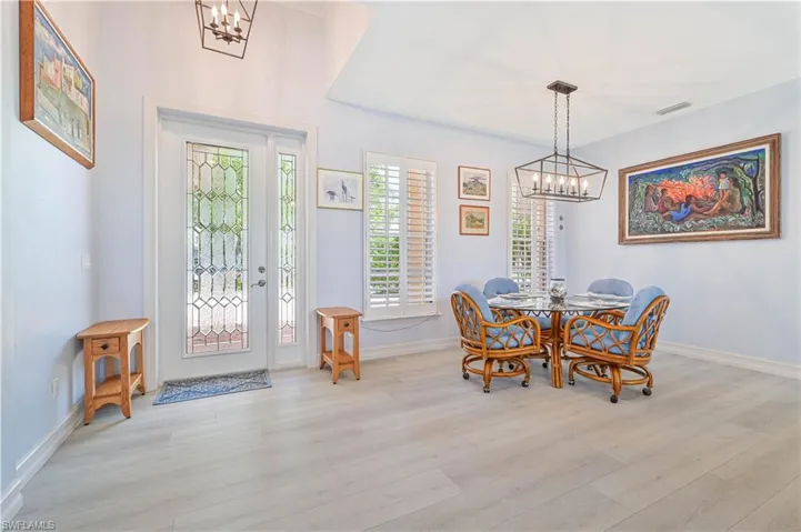 Dining space with an inviting chandelier and light hardwood / wood-style flooring
