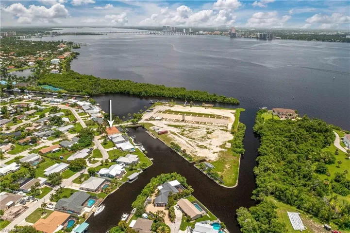 Birds eye view of property with a water view