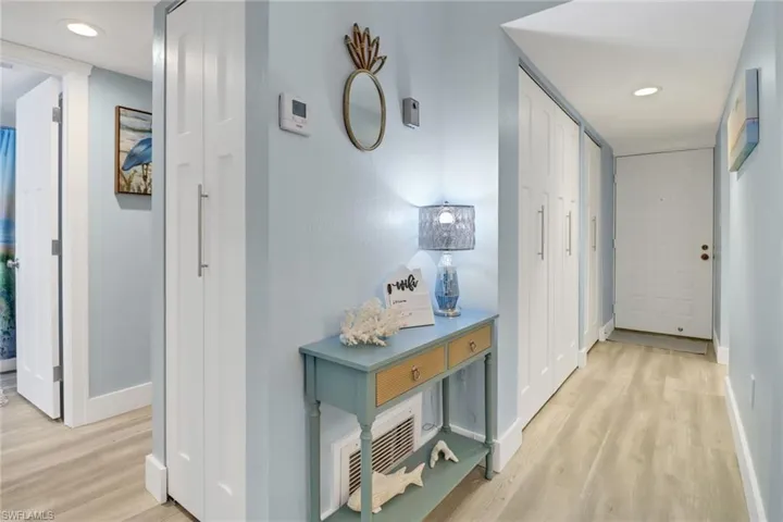 Corridor with light hardwood / wood-style flooring