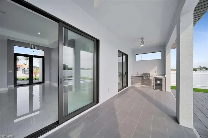 View of patio / terrace featuring a grill, exterior kitchen, and ceiling fan
