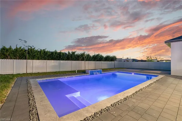 Pool at dusk with pool water feature