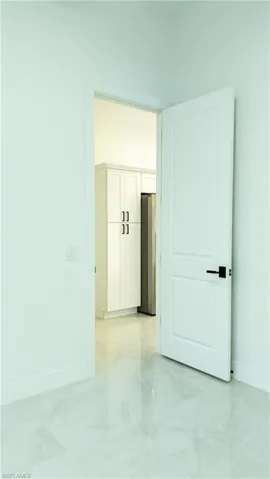 White paneled door with black hardware