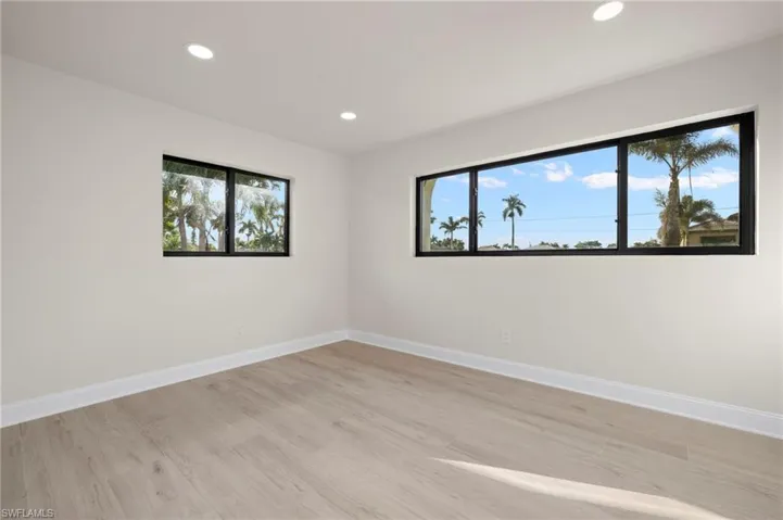 Empty room with a healthy amount of sunlight and light hardwood / wood-style flooring